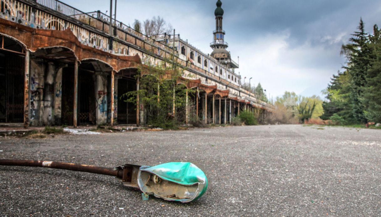 La città lombarda di Consonno abbandonata negli anni 60, con un lampione abbattuto in primo piano e rovine sullo sfondo