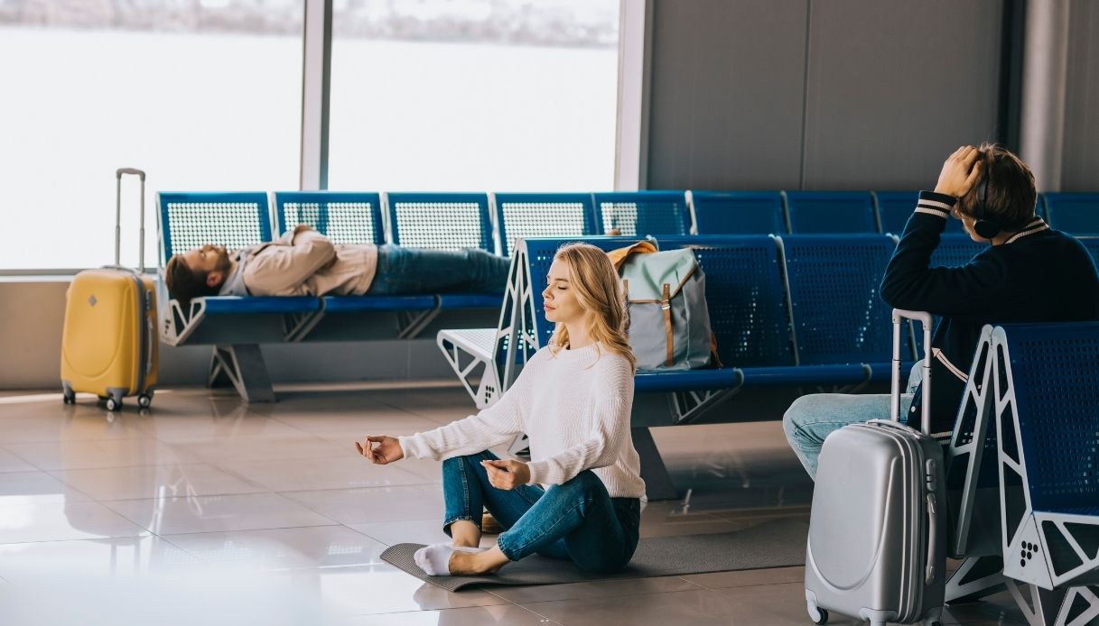 Donna che fa yoga e meditazione in aeroporto